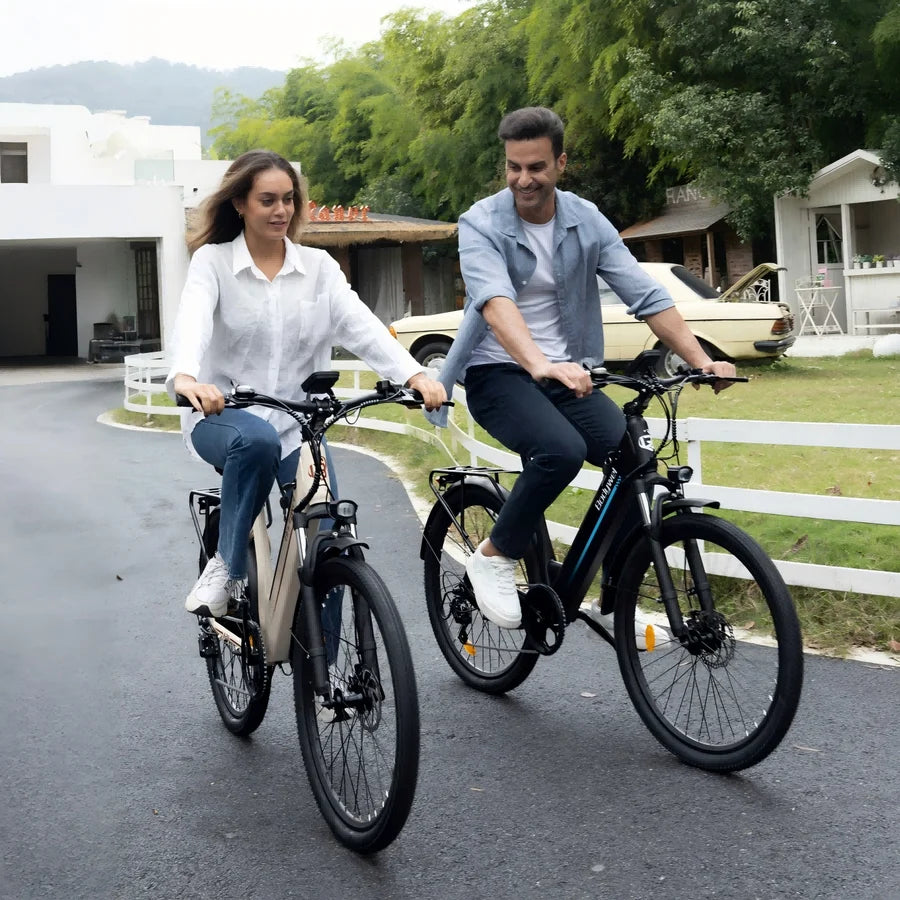 Two people riding electric bikes on a road with a scenic background